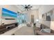 Bright living room with modern furniture, TV, and sliding doors to the porch at 8348 Catamaran Cir, Lakewood Ranch, FL 34202