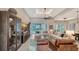 Bright living room with leather chairs, high ceilings, and large windows overlooking the pool at 8348 Catamaran Cir, Lakewood Ranch, FL 34202