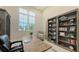 Bright home office with a view and custom shelving at 8348 Catamaran Cir, Lakewood Ranch, FL 34202