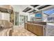 Luxurious outdoor kitchen features a marble counter, with bar and fireplace beyond at 8348 Catamaran Cir, Lakewood Ranch, FL 34202