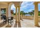 Elegant outdoor patio featuring stately columns and stunning lake views perfect for relaxing and entertaining at 8348 Catamaran Cir, Lakewood Ranch, FL 34202