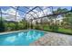 Sparkling pool surrounded by lush greenery, perfect for relaxation and outdoor enjoyment at 8348 Catamaran Cir, Lakewood Ranch, FL 34202