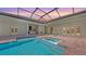 Inviting screened-in pool and spa surrounded by pavers, with covered outdoor living space at 8348 Catamaran Cir, Lakewood Ranch, FL 34202