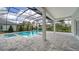 Resort-style pool and spa under a screened enclosure amidst lush landscaping at 8348 Catamaran Cir, Lakewood Ranch, FL 34202
