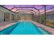 Inviting screened-in pool area with a serene water view at dusk provides the perfect outdoor retreat at 8348 Catamaran Cir, Lakewood Ranch, FL 34202