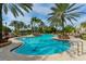 Beautiful resort-style pool with mature palm trees and ample lounge chairs at 8348 Catamaran Cir, Lakewood Ranch, FL 34202