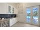 Wet bar with wine cooler, granite counters, subway tile, and access to the backyard pool at 8348 Catamaran Cir, Lakewood Ranch, FL 34202