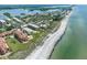 An aerial view features beach, buildings, and calm waters creating a peaceful vista at 8767 Midnight Pass Rd # 403F, Sarasota, FL 34242