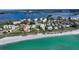 Aerial view of waterfront condos, sandy beach and beautiful ocean, for a luxurious coastal living at 8767 Midnight Pass Rd # 403F, Sarasota, FL 34242