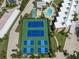 An aerial shot showcasing the tennis and pickle ball courts, and a community pool at 8767 Midnight Pass Rd # 403F, Sarasota, FL 34242