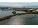 An aerial view featuring a marina, and waterfront restaurants near the Island Reef Condos at 8767 Midnight Pass Rd # 403F, Sarasota, FL 34242