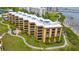 Aerial view of the condo building with well-maintained landscaping and waterfront access at 8767 Midnight Pass Rd # 403F, Sarasota, FL 34242