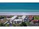 Aerial view of beachfront condos, a pool, and private beach access at 8767 Midnight Pass Rd # 403F, Sarasota, FL 34242