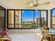 This balcony features a tile floor, a ceiling fan and panoramic waterfront views at 8767 Midnight Pass Rd # 403F, Sarasota, FL 34242