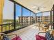 Spacious balcony with tiled flooring, ceiling fan, and beautiful view from this perfect spot for relaxing and entertaining at 8767 Midnight Pass Rd # 403F, Sarasota, FL 34242