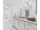 Bathroom featuring granite counters, a white vanity, and a connected water closet at 8767 Midnight Pass Rd # 403F, Sarasota, FL 34242
