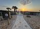 Gated beach access with a clock at sunset at 8767 Midnight Pass Rd # 403F, Sarasota, FL 34242