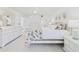 Bright bedroom featuring coastal decor, white furniture, and a comfortable king-sized bed at 8767 Midnight Pass Rd # 403F, Sarasota, FL 34242