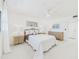 Bright bedroom with a king bed, white interior, and serene art on the walls at 8767 Midnight Pass Rd # 403F, Sarasota, FL 34242
