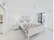 Bright bedroom with a white interior featuring a king bed and sliding doors to a balcony at 8767 Midnight Pass Rd # 403F, Sarasota, FL 34242
