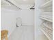Walk-in closet with built-in shelving and ample storage space for clothes and accessories at 8767 Midnight Pass Rd # 403F, Sarasota, FL 34242