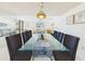 Bright dining room features a glass table with seating for eight, perfect for entertaining guests in style at 8767 Midnight Pass Rd # 403F, Sarasota, FL 34242