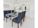 Dining room with a glass table, seating for six, and views of the modern kitchen at 8767 Midnight Pass Rd # 403F, Sarasota, FL 34242