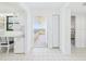 Hallway view leads to a patio with water views, a built-in desk and a bedroom at 8767 Midnight Pass Rd # 403F, Sarasota, FL 34242