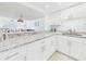 Kitchen featuring white cabinets, subway tile backsplash and a granite countertop at 8767 Midnight Pass Rd # 403F, Sarasota, FL 34242