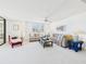 Airy living room with neutral-toned furnishings, plantation shutters, and ample natural light, creating a relaxing atmosphere at 8767 Midnight Pass Rd # 403F, Sarasota, FL 34242