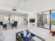 Open floor plan seamlessly connects the dining area and living room with a glass door that leads to a patio at 8767 Midnight Pass Rd # 403F, Sarasota, FL 34242