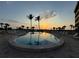 Tranquil pool featuring palm trees and breathtaking sunset views, perfect for relaxation at 8767 Midnight Pass Rd # 403F, Sarasota, FL 34242