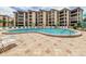 Large swimming pool with a spacious deck area and comfortable lounge seating near the condo building at 8767 Midnight Pass Rd # 403F, Sarasota, FL 34242