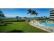 Scenic lawn and pool area overlooking the beach, providing a resort-like atmosphere at 8767 Midnight Pass Rd # 403F, Sarasota, FL 34242