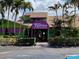 Exterior of the Turtles restaurant, decorated with palm trees and vibrant colors at 8767 Midnight Pass Rd # 403F, Sarasota, FL 34242