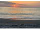 Calm beach during a sunset, displaying the sun's reflection on the water at 8767 Midnight Pass Rd # 403F, Sarasota, FL 34242