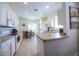 Well-maintained kitchen with white appliances, tiled floors, ample cabinet space, and a cozy breakfast nook at 8859 Founders Cir, Palmetto, FL 34221