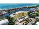 Aerial view of condominium complex, with boat docks, parking, and manicured landscaping at 9122 Midnight Pass Rd # 24, Sarasota, FL 34242