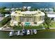 Luxury waterfront condominium features private boat slips, lush landscaping, and waterfront pool at 9122 Midnight Pass Rd # 24, Sarasota, FL 34242