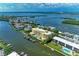Waterfront condominium with a boat dock, swimming pool, and manicured landscaping at 9122 Midnight Pass Rd # 24, Sarasota, FL 34242