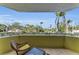 Balcony view surrounded by palm trees; a perfect outdoor spot for relaxation at 9122 Midnight Pass Rd # 24, Sarasota, FL 34242