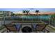 Balcony view with two chairs overlooking waterfront, offering a relaxing spot to enjoy the scenic views and tranquil atmosphere at 9122 Midnight Pass Rd # 24, Sarasota, FL 34242