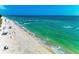 Idyllic beach with clear turquoise water, gentle waves, and few people enjoying the sunny day at 9122 Midnight Pass Rd # 24, Sarasota, FL 34242
