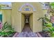 Inviting entrance to the condo building, featuring brick pavers and elegant architectural details at 9122 Midnight Pass Rd # 24, Sarasota, FL 34242