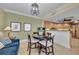 Cozy dining area with a round table, perfect for intimate meals, adjacent to the kitchen and living space at 9122 Midnight Pass Rd # 24, Sarasota, FL 34242