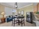 Cozy dining area featuring a round table, comfortable seating, and wine cooler at 9122 Midnight Pass Rd # 24, Sarasota, FL 34242