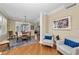 Elegant dining area with chandelier, hardwood floors, and wainscoting detail at 9122 Midnight Pass Rd # 24, Sarasota, FL 34242