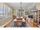 Bright dining room featuring a chandelier, large windows, and wood floors at 9122 Midnight Pass Rd # 24, Sarasota, FL 34242
