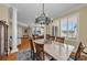 Open concept dining area with stone table, wood chairs, and natural light at 9122 Midnight Pass Rd # 24, Sarasota, FL 34242