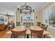 Dining room featuring a stone table, hardwood chairs, and window with shutters at 9122 Midnight Pass Rd # 24, Sarasota, FL 34242